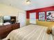 Bedroom featuring colorful walls and Mickey Mouse wall art with a queen bed at 4865 Clock Tower Dr, Kissimmee, FL 34746