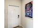 Hallway featuring a white door with a digital lock, and Disney themed art on the wall at 4865 Clock Tower Dr, Kissimmee, FL 34746