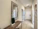 Hallway with tile flooring, decorative mirror, console table, and multiple doorways at 4865 Clock Tower Dr, Kissimmee, FL 34746