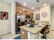 A cozy kitchen featuring stainless steel appliances, granite countertops and a breakfast bar at 4865 Clock Tower Dr, Kissimmee, FL 34746