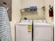 The laundry room features a washer, dryer, and ironing board at 4865 Clock Tower Dr, Kissimmee, FL 34746