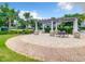 Outdoor pergola and seating area in a common area for relaxing with Gathering and friends at 4865 Clock Tower Dr, Kissimmee, FL 34746