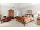 Bedroom features a patterned comforter, armoire, ceiling fan, and red chair at 5940 Chesapeake Park, Unit # 47, Orlando, FL 32819