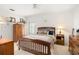 Cozy bedroom features a wood bed frame, white walls, and vintage-inspired decor at 5940 Chesapeake Park, Unit # 47, Orlando, FL 32819