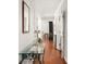 Hallway with hardwood floors and a glass-topped console table at 5940 Chesapeake Park, Unit # 47, Orlando, FL 32819