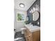 Stylish bathroom with a wood vanity, vessel sink, and modern fixtures against a dark accent wall at 7416 Kadel Way, Orlando, FL 32822