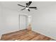 Simple bedroom with hardwood floors, closet, and ceiling fan at 7416 Kadel Way, Orlando, FL 32822