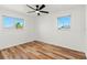 Bedroom with hardwood floors and natural light streaming through the windows at 7416 Kadel Way, Orlando, FL 32822