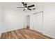 Cozy bedroom with hardwood floors, closet, and a ceiling fan at 7416 Kadel Way, Orlando, FL 32822