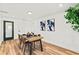 Dining room showcasing a wooden table, comfortable seating, and minimalist wall art at 7416 Kadel Way, Orlando, FL 32822