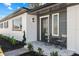 Cozy front porch with seating, stylish gray and white exterior, and fresh landscaping at 7416 Kadel Way, Orlando, FL 32822