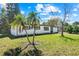 Charming single-story home with well-maintained lawn and lush palm trees at 7416 Kadel Way, Orlando, FL 32822