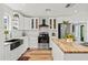 Bright kitchen featuring white cabinetry, stainless steel appliances, and a butcher block island at 7416 Kadel Way, Orlando, FL 32822