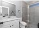 Modern bathroom featuring a glass shower, light gray tile, and white quartz countertop with stylish black hardware at 7651 Sw 74Th Loop, Ocala, FL 34481