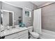 Well-lit bathroom featuring a vanity with quartz countertop, tiled shower-tub combo, and modern fixtures at 7651 Sw 74Th Loop, Ocala, FL 34481