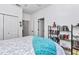 Bright bedroom with white walls, an accent bookshelf, and modern decorations creating a cozy space at 7651 Sw 74Th Loop, Ocala, FL 34481