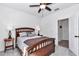 A bright bedroom showcases a wooden bed frame, complemented by modern bedside lamps and neutral walls, creating a peaceful retreat at 7651 Sw 74Th Loop, Ocala, FL 34481