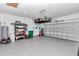 Well-organized garage with epoxy flooring, storage racks, and ample space for vehicles and equipment at 7651 Sw 74Th Loop, Ocala, FL 34481