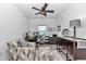 This home office features a computer desk, ample storage, and patterned seating to create a functional workspace at 7651 Sw 74Th Loop, Ocala, FL 34481