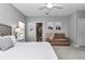 Bright main bedroom features an ensuite bathroom, comfortable seating area, and neutral decor at 7651 Sw 74Th Loop, Ocala, FL 34481