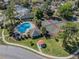 Aerial shot featuring a community pool and tennis court surrounded by mature trees at 7861 Copperfield Ct, Orlando, FL 32825