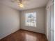 Bedroom featuring wood floors, a ceiling fan with light, and a large window at 7861 Copperfield Ct, Orlando, FL 32825