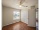 Bedroom featuring wood floors, a ceiling fan with light, and a closet with folding doors at 7861 Copperfield Ct, Orlando, FL 32825