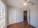 Bedroom featuring wood floors, a ceiling fan with light, and a closet with folding doors at 7861 Copperfield Ct, Orlando, FL 32825