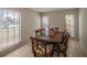 Dining room featuring a wood table and chairs, with three large windows providing plenty of natural light at 7861 Copperfield Ct, Orlando, FL 32825