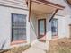 Inviting entryway with updated door and hardware, complemented by sidelight windows at 7861 Copperfield Ct, Orlando, FL 32825