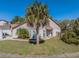 Inviting two-story home with lush landscaping and a well-manicured lawn under a clear blue sky at 7861 Copperfield Ct, Orlando, FL 32825