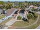 Two-story home features a large front yard, driveway, and solar panels on the roof at 7861 Copperfield Ct, Orlando, FL 32825