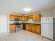 Functional kitchen with wood cabinets, stainless steel appliances, and tile flooring, with a clean and practical design at 7861 Copperfield Ct, Orlando, FL 32825