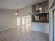 Open-concept living room with high ceilings, neutral paint, and tile flooring, with stairs leading to the second floor at 7861 Copperfield Ct, Orlando, FL 32825