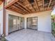 Covered patio with tile flooring and sliding glass doors to the interior at 7861 Copperfield Ct, Orlando, FL 32825