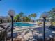 Community pool and seating area surrounded by trees and landscaping at 7861 Copperfield Ct, Orlando, FL 32825