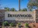 Community sign with the name Devonwood surrounded by stone and greenery at 7861 Copperfield Ct, Orlando, FL 32825