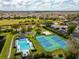 Aerial view of community pool, tennis courts, and surrounding neighborhood at 8606 Terrace Pines Ct, Orlando, FL 32836