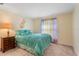 Bedroom featuring a colorful rainbow decoration above a bed with blue bedding and a nightstand at 8606 Terrace Pines Ct, Orlando, FL 32836