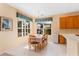 Dining area featuring large windows, a table with seating for six, and neutral decor, creating a welcoming and bright atmosphere at 8606 Terrace Pines Ct, Orlando, FL 32836