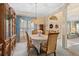 Formal dining room with chandelier, china cabinet, and elegant table setting at 8606 Terrace Pines Ct, Orlando, FL 32836