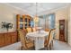 Formal dining room with chandelier, china cabinet, and elegant table setting at 8606 Terrace Pines Ct, Orlando, FL 32836