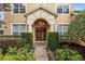 Elegant front entrance features a beautiful archway, double doors, and manicured landscaping at 8606 Terrace Pines Ct, Orlando, FL 32836