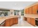 Open kitchen area featuring ample cabinetry, a wraparound bar, stainless steel appliances, and a bright eat-in space with large windows at 8606 Terrace Pines Ct, Orlando, FL 32836