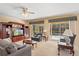 Open living room features a ceiling fan, entertainment center, and view of the pool at 8606 Terrace Pines Ct, Orlando, FL 32836