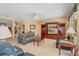 Cozy living room with plush seating, a ceiling fan, and a custom entertainment center with built-in shelving and a large TV at 8606 Terrace Pines Ct, Orlando, FL 32836