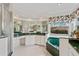 Main bathroom features dual sinks, a vanity area, garden tub with green marble accents, and mirrors for a luxurious aesthetic at 8606 Terrace Pines Ct, Orlando, FL 32836