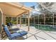 Enclosed pool and patio area with lounge chairs and outdoor seating offer a relaxing backyard oasis at 8606 Terrace Pines Ct, Orlando, FL 32836