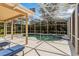 A refreshing in-ground pool with a screened enclosure offers the perfect space for backyard fun at 8606 Terrace Pines Ct, Orlando, FL 32836