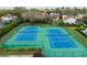 Dual tennis courts with green fencing provide ample opportunities for sports and recreation at 8606 Terrace Pines Ct, Orlando, FL 32836